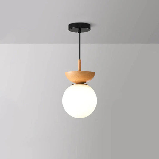 Nordisk pendellampa i glas med rund opal kupa och träsockel för hall och vardagsrum